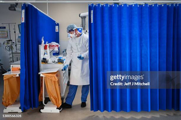 Nurse at University Hospital Monklands disposes of medical waste on the ICU ward on February 5, 2021 in Airdrie, Scotland. The numbers of patients...