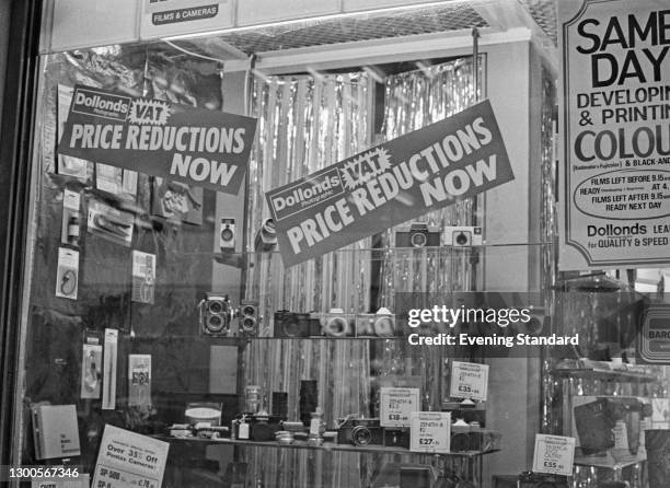 Signs in the window of a Dollonds photographic equipment store in London, advertising VAT price reductions, UK, 3rd April 1973. VAT replaced Purchase...