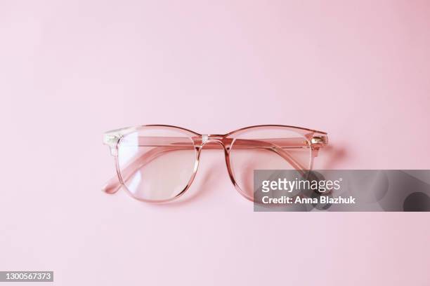 trendy modern minimalistic flat lay with eyeglasses over pink background - spectacles stock pictures, royalty-free photos & images