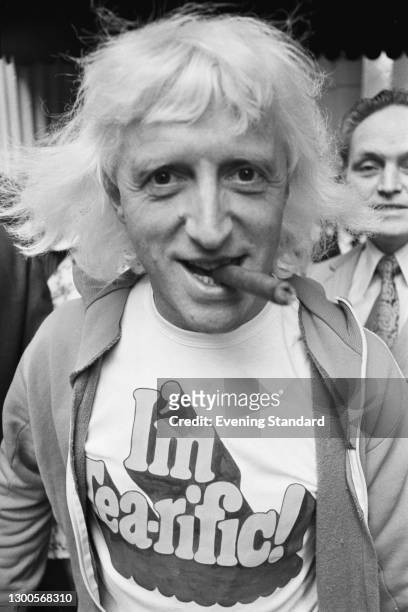 English disc jockey and television personality Jimmy Savile wearing a t-shirt which reads 'I'm Tea-rific' during a Variety Club of Great Britain...