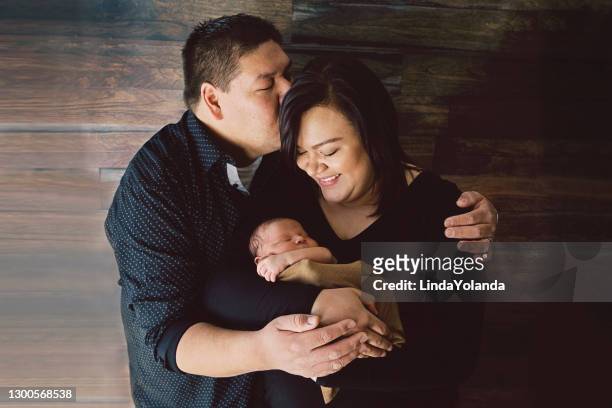 mother and father holding newborn - native american family stock pictures, royalty-free photos & images
