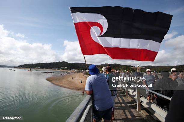 People watch as kids jump off the bridge for a swim on February 06, 2021 in Waitangi, New Zealand. The Waitangi Day national holiday celebrates the...