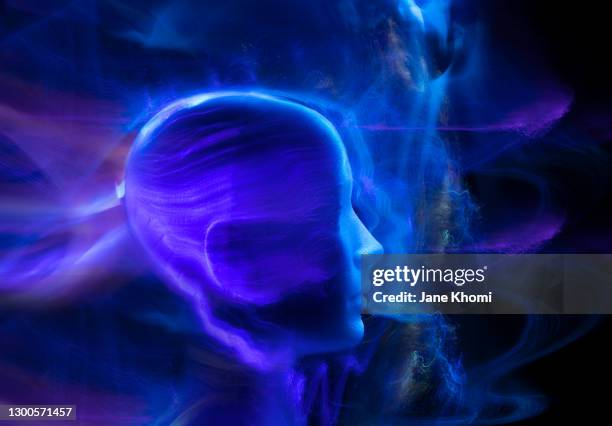 woman silhouette in neon blue light - radiacion electro magnetica fotografías e imágenes de stock