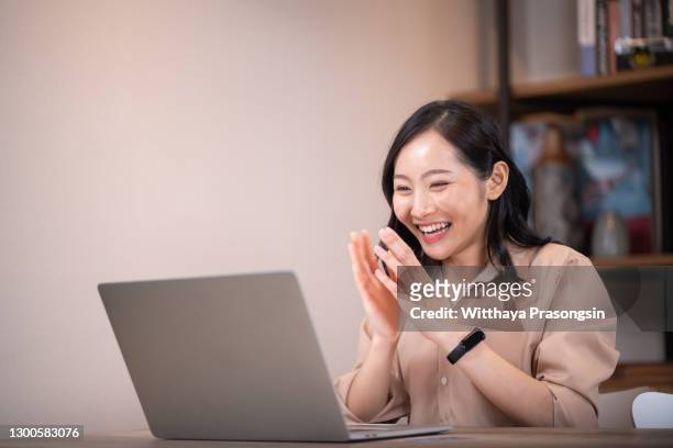 young asian girl working at a coffee shop with a laptop - excitement laptop stock pictures, royalty-free photos & images