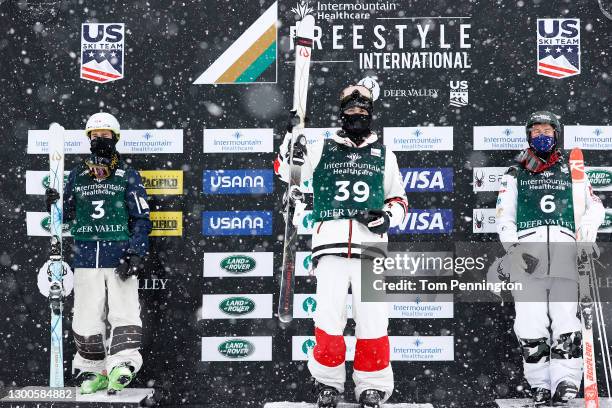 Matt Graham of Australia in second place, Mikael Kingsbury of Canada in first place and Benjamin Cavet of France in third place celebrate on the...