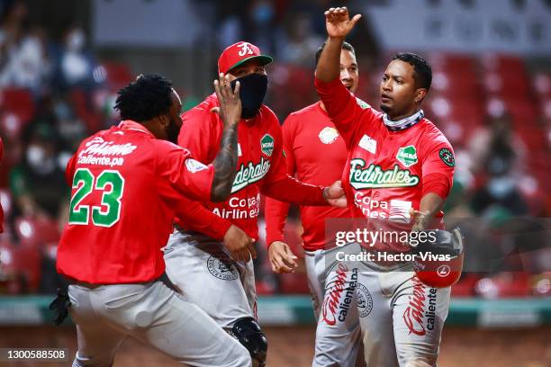 Jorge Bishop of Federales de Chiriquí of Panama celebrates with teammates after scoring in the 9th inning during a match between Dominican Republic...