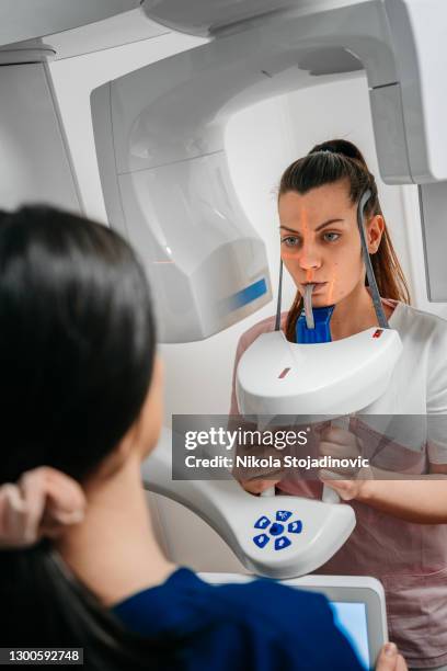 dentist taking a panoramic digital x-ray of a patient s teeth - x-ray technician stock pictures, royalty-free photos & images