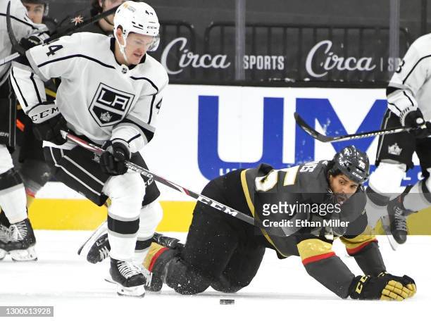 Ryan Reaves of the Vegas Golden Knights falls to the ice as he defends without a stick against Mikey Anderson of the Los Angeles Kings after Reaves'...