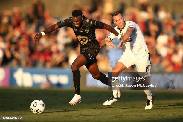 Bernie Ibini-Isei of the Wanderers is challenged by Aleksandar Susnjar of the Bulls during the A-League match between Macarthur FC and the Western...