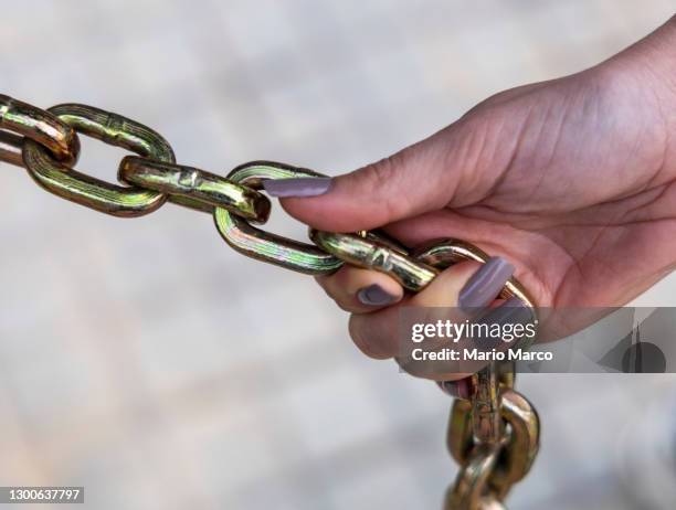 chain and woman's hand - key ring isolated stockfoto's en -beelden