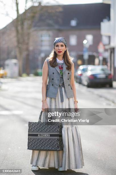 Alexandra Lapp is seen wearing CHRISTIAN DIOR Cruise collection 2021, vest in grey, CHRISTIAN DIOR wrap top with flower print in grey, CHRISTIAN DIOR...