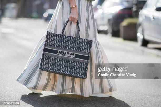 Alexandra Lapp is seen wearing CHRISTIAN DIOR Cruise collection 2021, CHRISTIAN DIOR striped maxi skirt in white and grey, personalized CHRISTIAN...