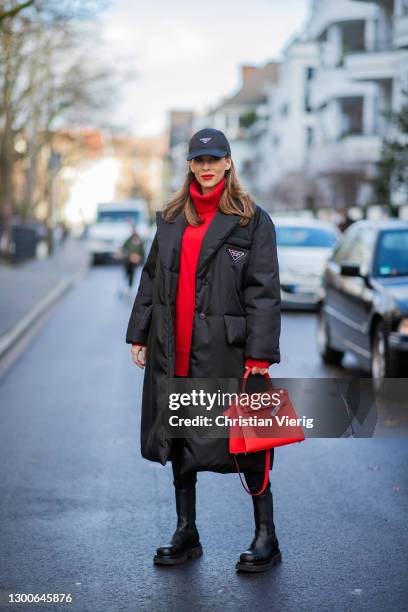 Alexandra Lapp is seen wearing PRADA Re-Nylon puffer coat in black, PRADA nylon cap in black FALCONERI cashmere turtle neck dress, HERMÈS Kelly 28...