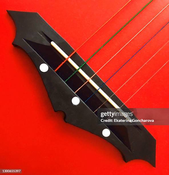 creative square background. close-up of a red guitar with strings and a sill - musical instrument string stock pictures, royalty-free photos & images