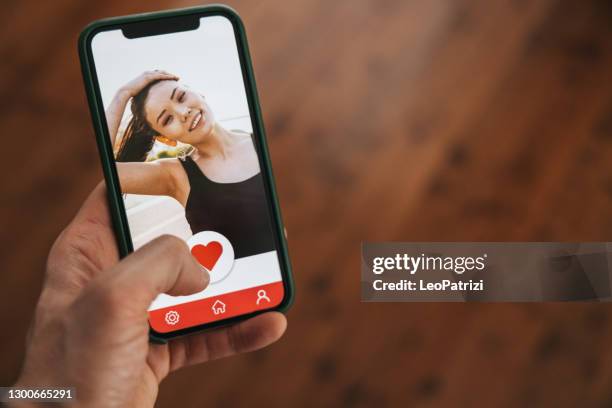 online dating. social media app on a device screen - dating app stock pictures, royalty-free photos & images
