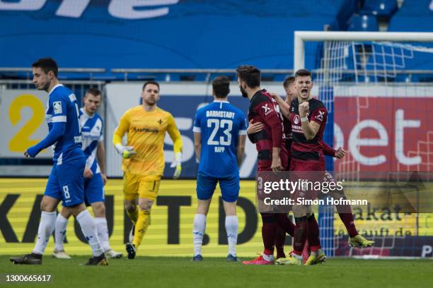 Tom Krauss of Nuernberg celebrates his team's second goal with his team mates during the Second Bundesliga match between SV Darmstadt 98 and 1. FC...