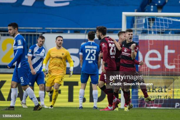 Tom Krauss of Nuernberg celebrates his team's second goal with his team mates during the Second Bundesliga match between SV Darmstadt 98 and 1. FC...