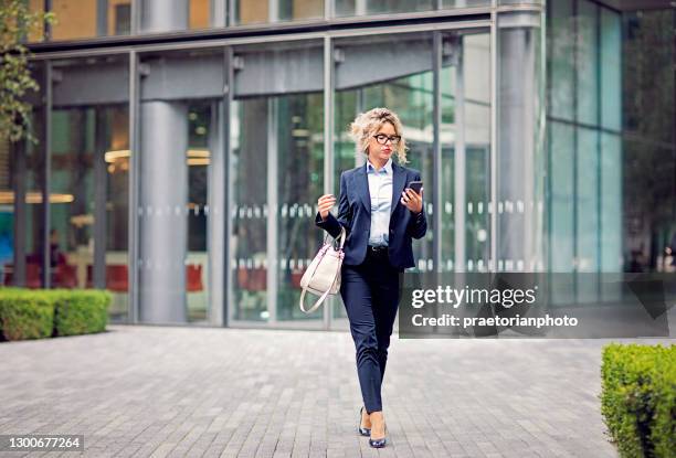 young businesswoman is exiting from her office - employee leaving stock pictures, royalty-free photos & images