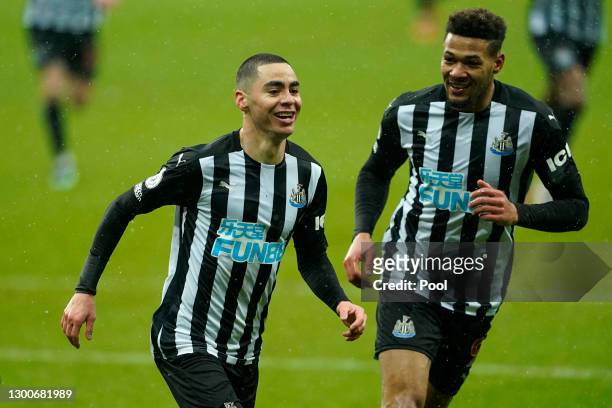 Miguel Almiron of Newcastle United celebrates with teammate Joelinton after scoring his team's third goal during the Premier League match between...