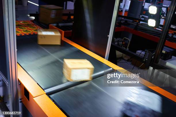 cardboard boxes on conveyor belt - yellow belt stock pictures, royalty-free photos & images