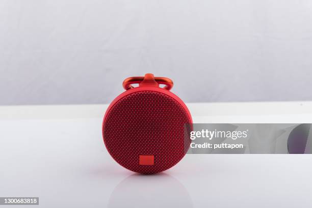 red wireless speaker isolated on white background - bluetooth speaker stock-fotos und bilder