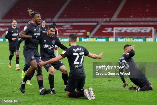 Vitaly Janelt of Brentford celebrates with teammates Ivan Toney and Sergi Canos after scoring his team's second goal during the Sky Bet Championship...