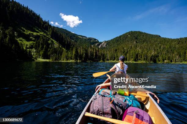 family canoeing on a stunning mountain lake - grand 8 stock pictures, royalty-free photos & images