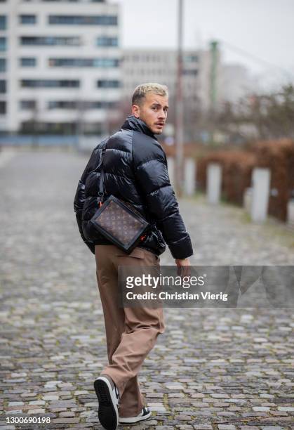 Louis Darcis is seen wearing black Pyrenex down feather jacket, vintage pants in beige brown, Nike Air Jordan sneaker, Louis Vuitton bag on February...