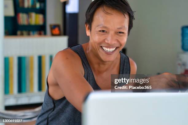thai man working from home on laptop video call - makeshift shelter stock pictures, royalty-free photos & images