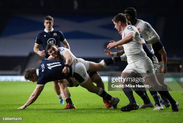 Duhan van der Merwe of Scotland breaks past Mark Wilson of England to score his sides first try during the Guinness Six Nations match between England...
