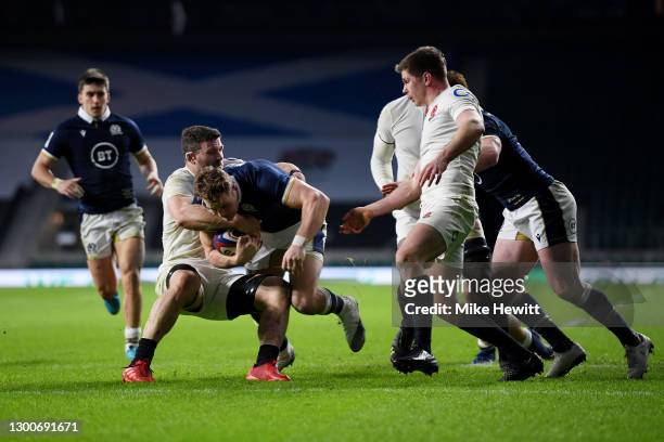 Duhan van der Merwe of Scotland breaks past Mark Wilson of England to score his sides first try during the Guinness Six Nations match between England...