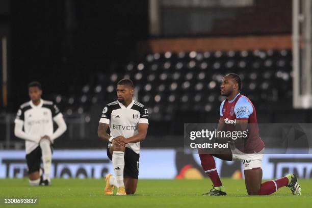 Ivan Cavaleiro of Fulham and Michail Antonio of West Ham United take a knee in support of the Black Lives Matter Movement prior to the Premier League...