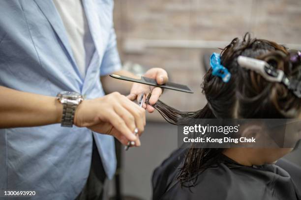 close-up asian chinese hairdresser cutting hair in saloon. barber shop. - hair color saloon stock pictures, royalty-free photos & images