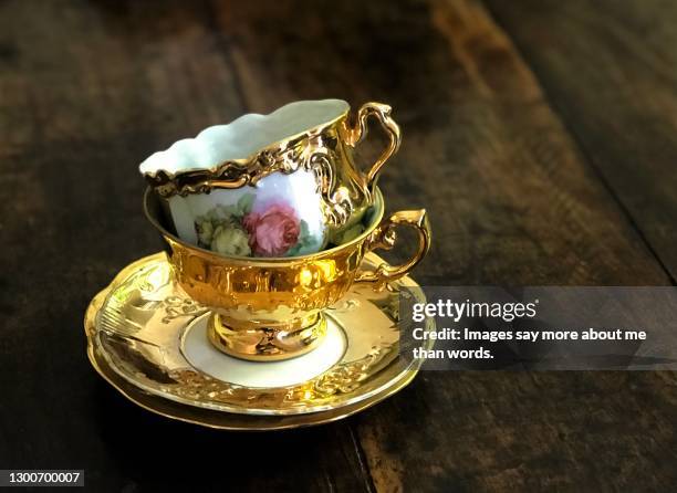 a pile of two gorgeous tea cups in gold. still life. - afternoon tea party bildbanksfoton och bilder