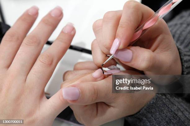 manicure treatment at nail shop - painting fingernails stock pictures, royalty-free photos & images