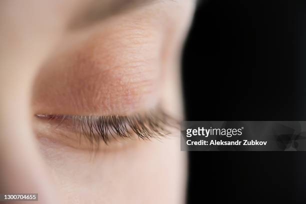 the woman's eye and eyelid look down, close-up. the concept of cosmetology, natural beauty. a copy of the space. - drooping stock pictures, royalty-free photos & images
