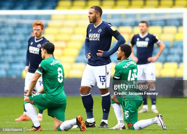 Millwall players stand as Sheffield Wednesday players take the knee in support of the Black Lives Matter movement during the Sky Bet Championship...