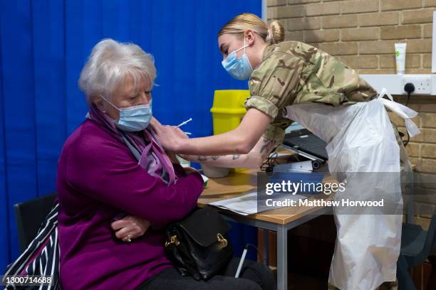 Member of the military vaccinates a woman at the COVID-19 mass vaccination centre at Pentwyn Leisure Centre on February 3, 2021 in Cardiff, Wales....