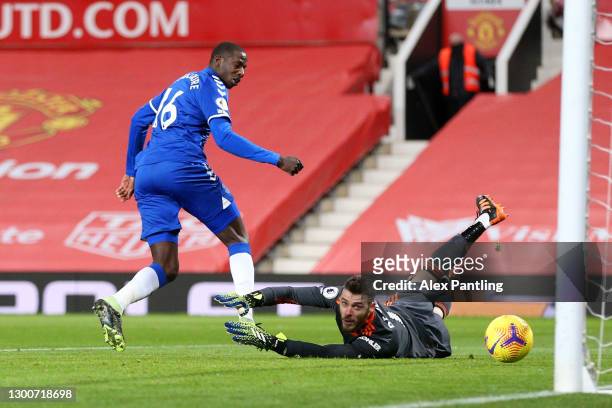 Abdoulaye Doucoure of Everton scores their team's first goal past David De Gea of Manchester United during the Premier League match between...