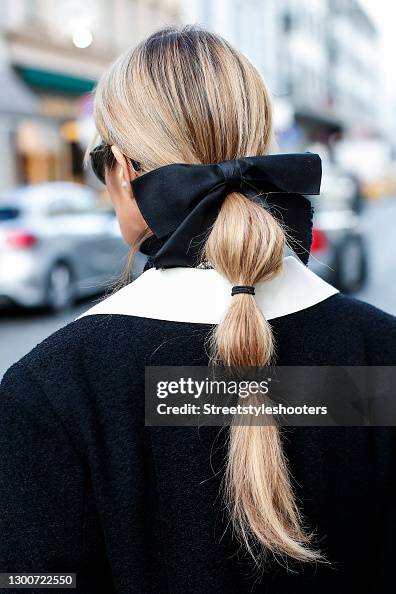 A low bubble ponytail hairstyle, a black bow hair clip by Chanel and  News Photo - Getty Images