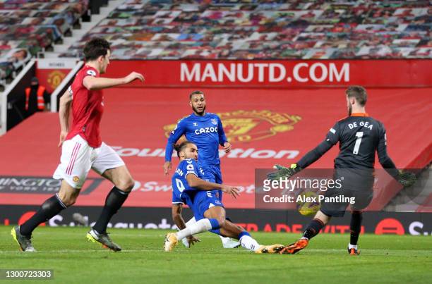Dominic Calvert-Lewin of Everton scores their team's third goal past David De Gea of Manchester United during the Premier League match between...