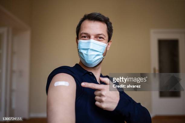 happy to be in first few to get vaccinated - man wearing protective face mask stock pictures, royalty-free photos & images