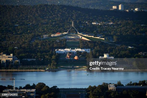 Crowds watch as Skywhalepapa is inflated in front of the Australian Parliament House next to the original Skywhale on February 07, 2021 in Canberra,...