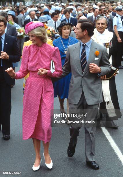 Prince Charles, Prince of Wales and Diana, Princess of Wales, wearing a pink and white polka dot dress designed by Donald Campbell and a pink hat...