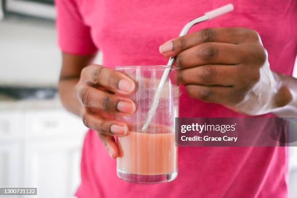 woman drinks smoothie with metal straw - metal straw stock pictures, royalty-free photos & images