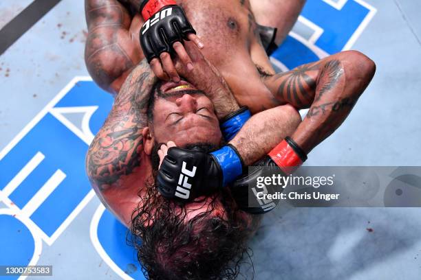 Clay Guida attempts to secure a rear choke submission against Michael Johnson in their lightweight fight during the UFC Fight Night event at UFC APEX...