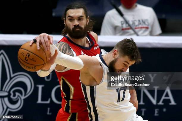 Steven Adams of the New Orleans Pelicans is fouled by Jonas Valanciunas of the Memphis Grizzlies during the second quarter of an NBA game at Smoothie...