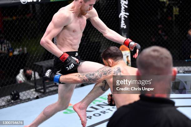 Cory Sandhagen lands a flying knee to knock out Frankie Edgar in their bantamweight fight during the UFC Fight Night event at UFC APEX on February...