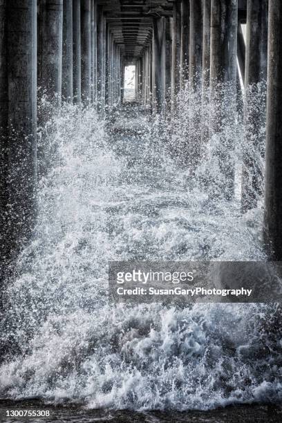 stormy waters under the pier - storm surge stock pictures, royalty-free photos & images