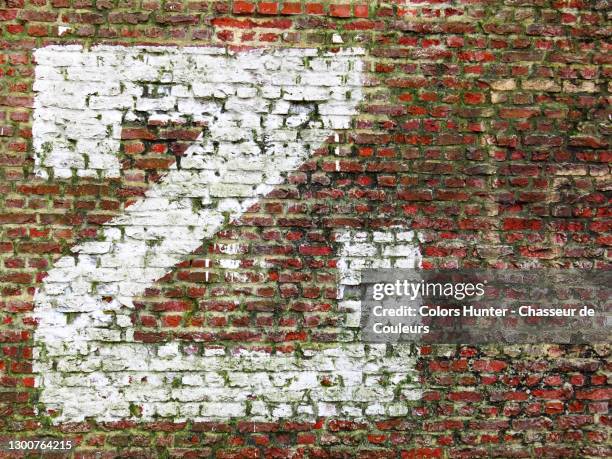 z painted and weathered on an abandoned brick house facade - letter z stock pictures, royalty-free photos & images